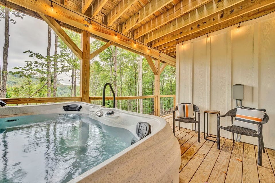 Relax in our serene outdoor hot tub surrounded by nature, complete with cozy seating under string lights