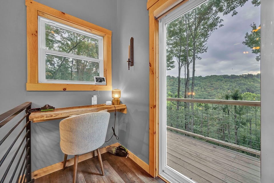 Cozy workspace with desk, natural light, and direct access to scenic outdoor deck