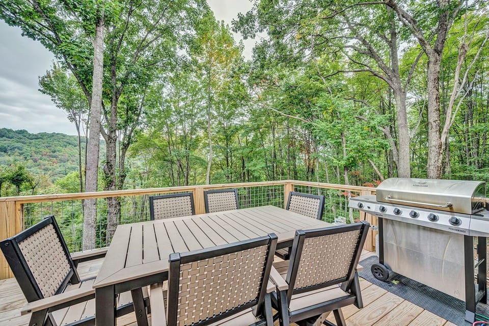 Scenic outdoor dining deck with seating for six, gas grill, and mountain views