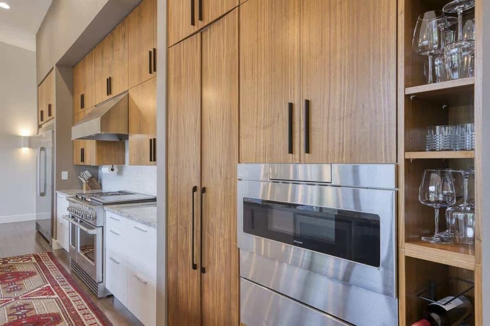 Designer kitchen featuring custom cabinetry, premium appliances, and elegant contemporary finishes.