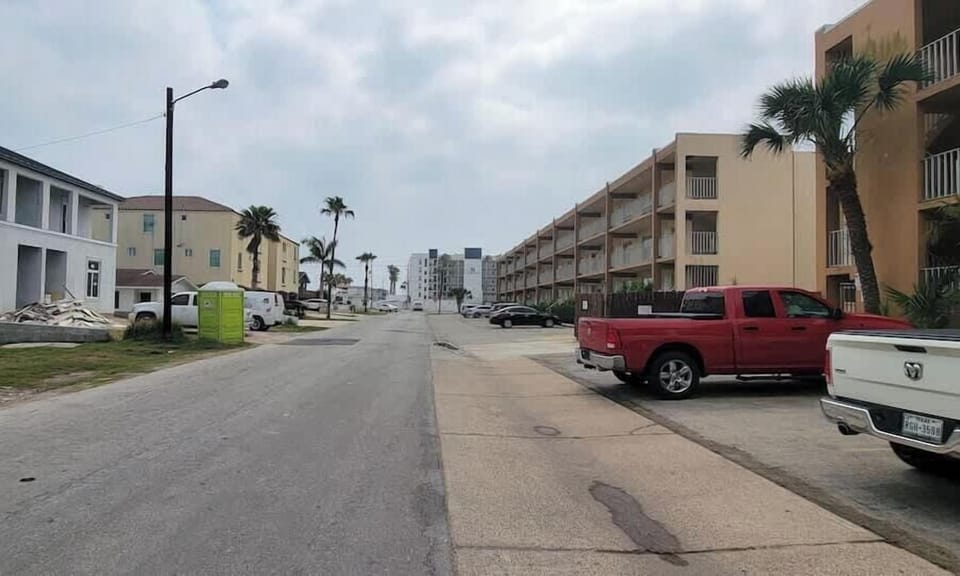Peaceful palm‑lined street offering a relaxed coastal atmosphere with easy access to nearby beaches, local cafés & walkable neighborhood charm. Bright skies, open views & a laid‑back tropical setting create an inviting arrival for your island gateway