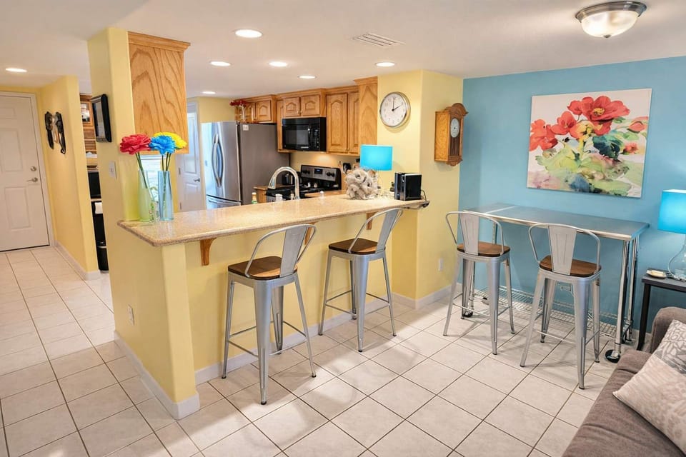 Bright & Colorful Kitchen + Dining | Stainless Steel Appliances | Granite Counters | Vibrant Art & Lighting | STR-Ready Space Near Beach & Attractions