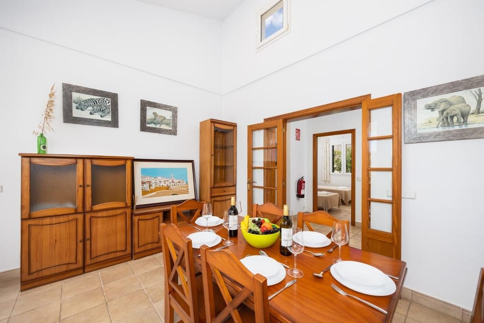 Living room with sofas, dining area, ornamental fireplace, WiFi internet, and satellite TV