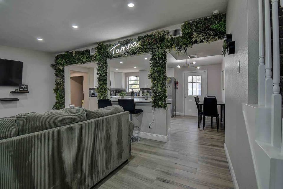 Unwind in the inviting living room featuring a cozy couch and smart TV for all your entertainment needs. #LivingRoomComfort #SmartTV #TampaStay