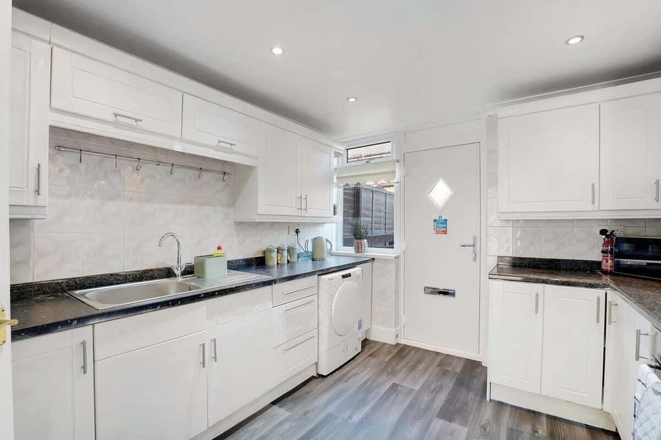 Kitchen equipped with all essentials, including a washer & dryer, oven, fridge and full cookware set.