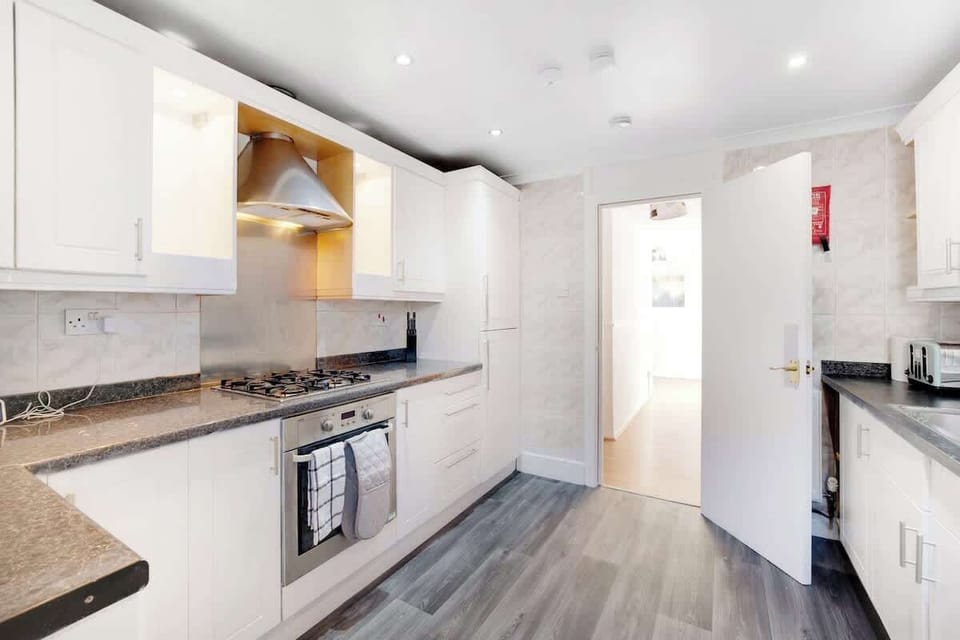 Kitchen equipped with all essentials, including a washer & dryer, oven, fridge and full cookware set.