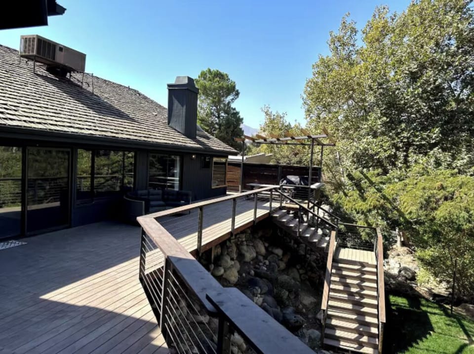 Charming setting with a serene river, rocks, and trees offering unique views.