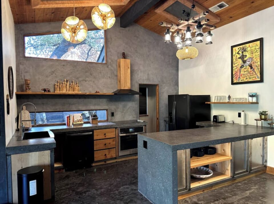 Open kitchen with rustic-modern finishes, wood accents, and a central island.