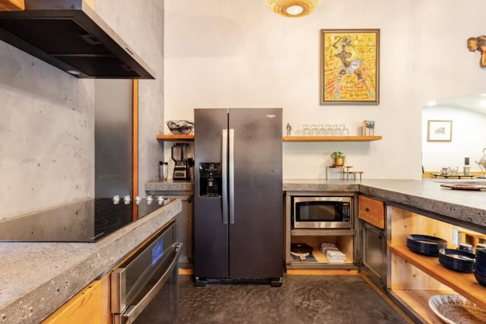 Open kitchen with rustic-modern finishes, wood accents, and a central island.