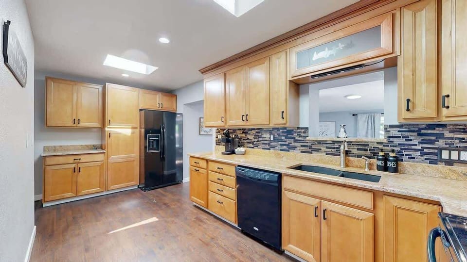 The kitchen offers plenty of counter space, providing ample room for meal prep, cooking, and entertaining with ease.