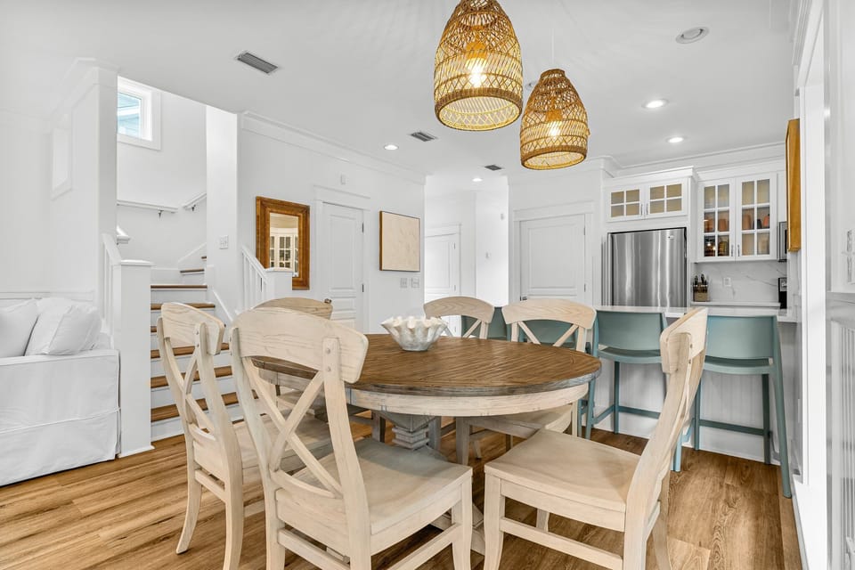 The dining area, situated between the living room and kitchen in an open-concept layout, features a six-person table, offering a perfect space for enjoying meals while staying connected to the heart of the home.