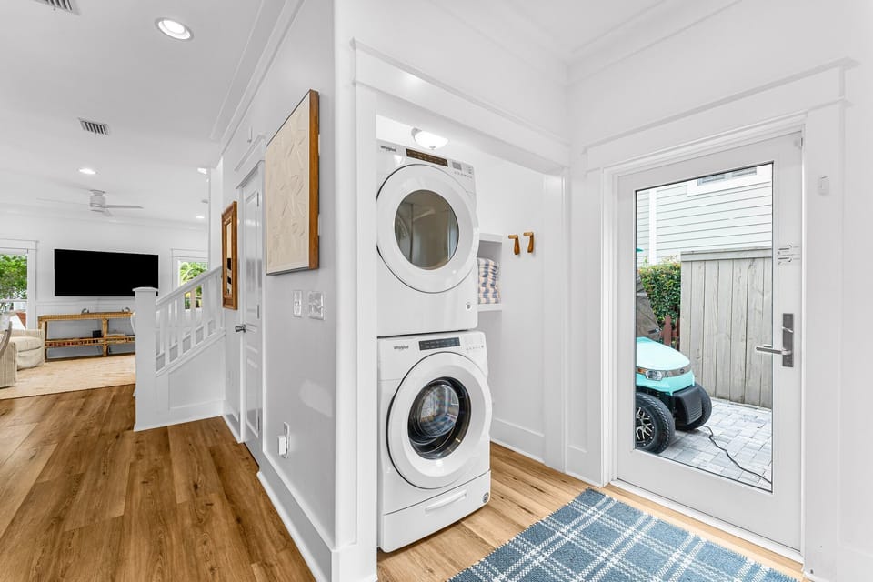 The laundry room, conveniently located off of the kitchen, is equipped with a full washer and dryer, ironing board, iron, and steam cleaner, providing guests with everything they need for easy laundry care during their stay.