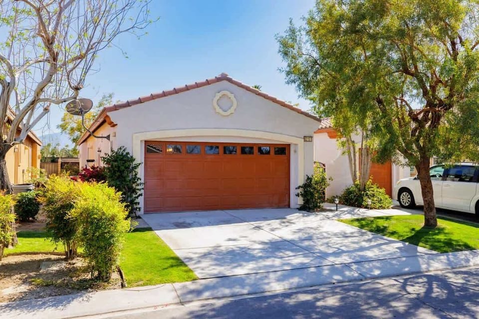 Lovely front entrance with private driveway and green surroundings