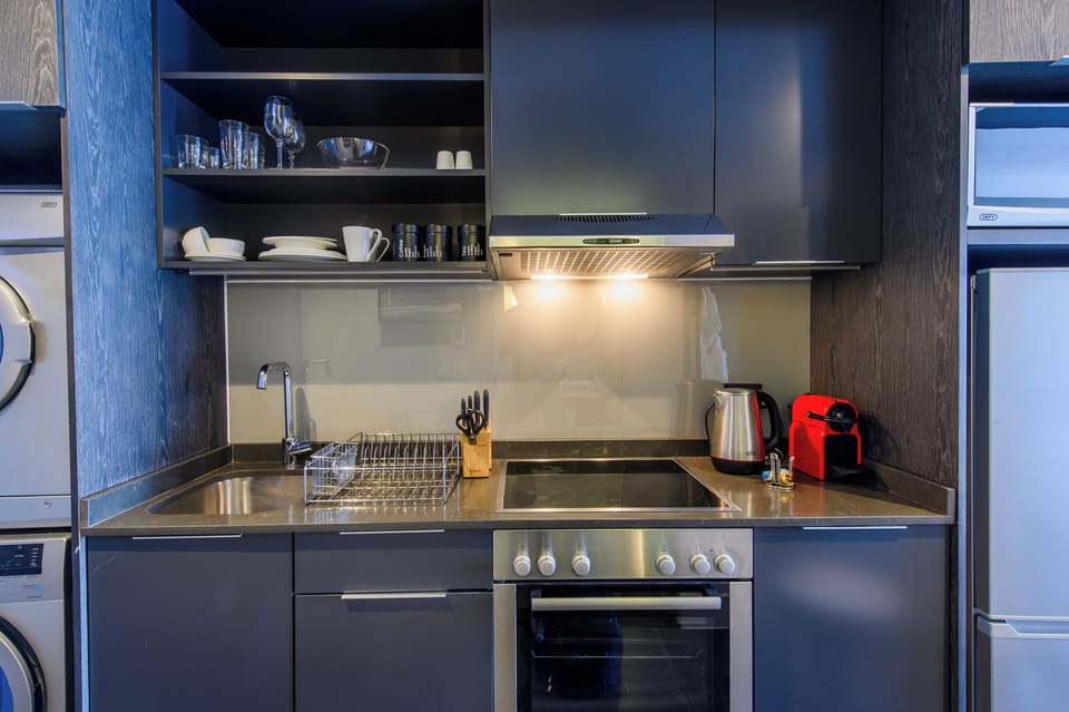 Luxury Suite, 1 King Bed, Ensuite | Private kitchen | Fridge, microwave, oven, stovetop