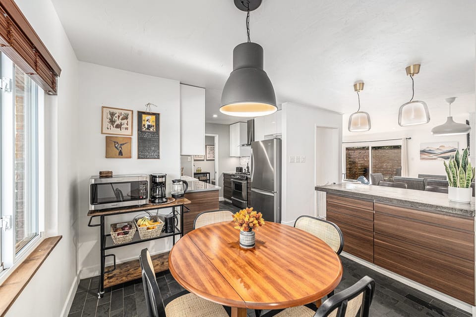 Bright and inviting breakfast nook just off the kitchen, offering a perfect spot for casual meals or enjoying a quiet moment.