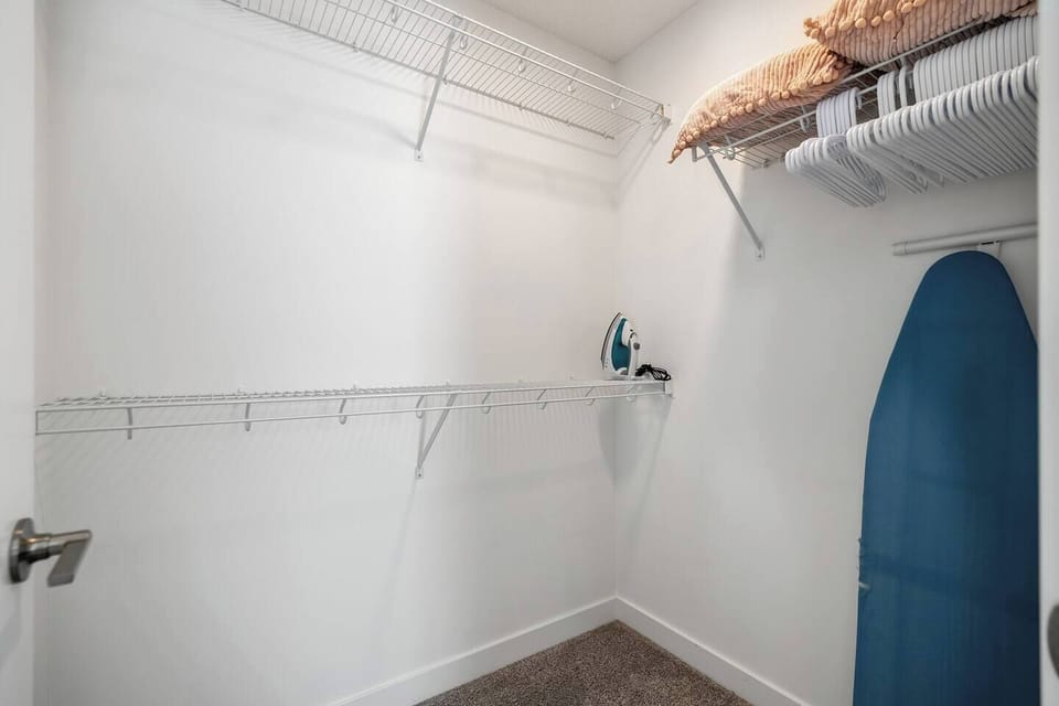 Master bedroom Walk in closet. Iron and Ironing board provided.