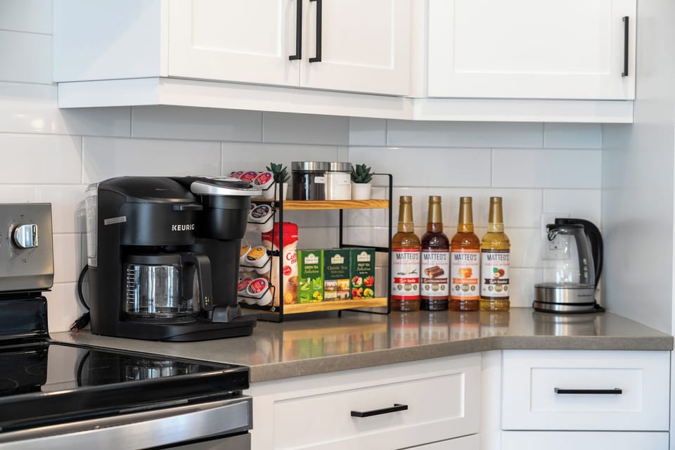 Start your mornings right with our cozy coffee station!!  Featuring a K-Duo Keurig machine, a variety of K-cups, coffee, tea, sugar, and delicious coffee syrups to customize your perfect cup.