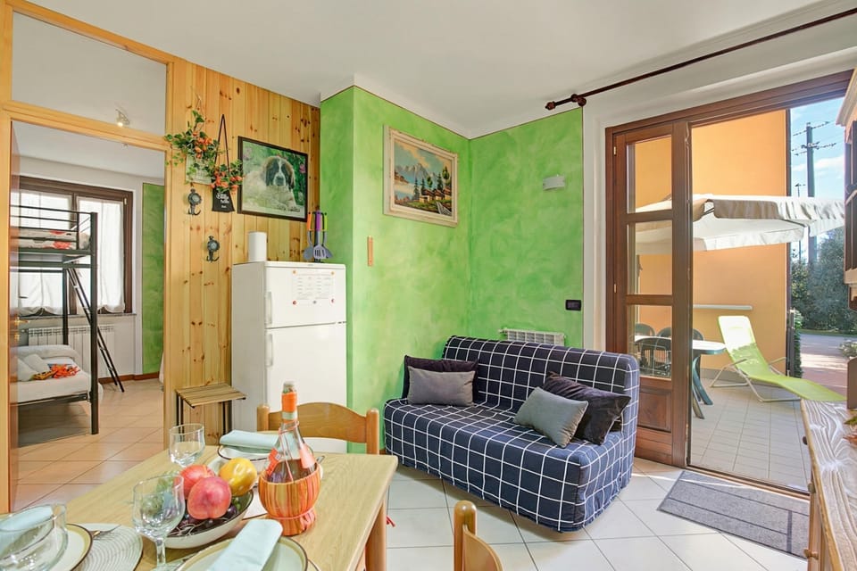Family Apartment, Multiple Bedrooms (Holiday Sun Puegnago | Terrace & Pool) | Living area | Flat-screen TV