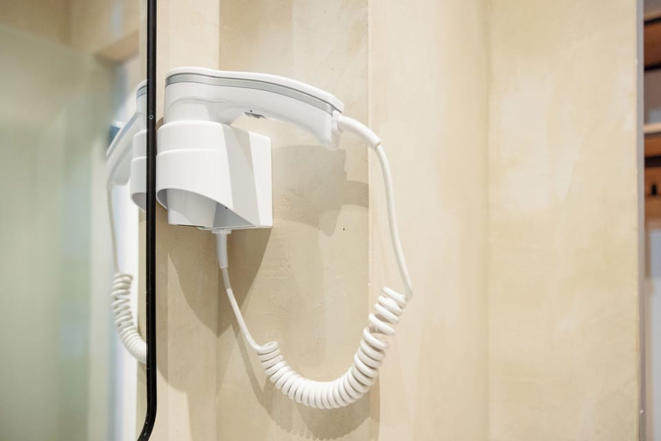 Shower, hair dryer, slippers, towels