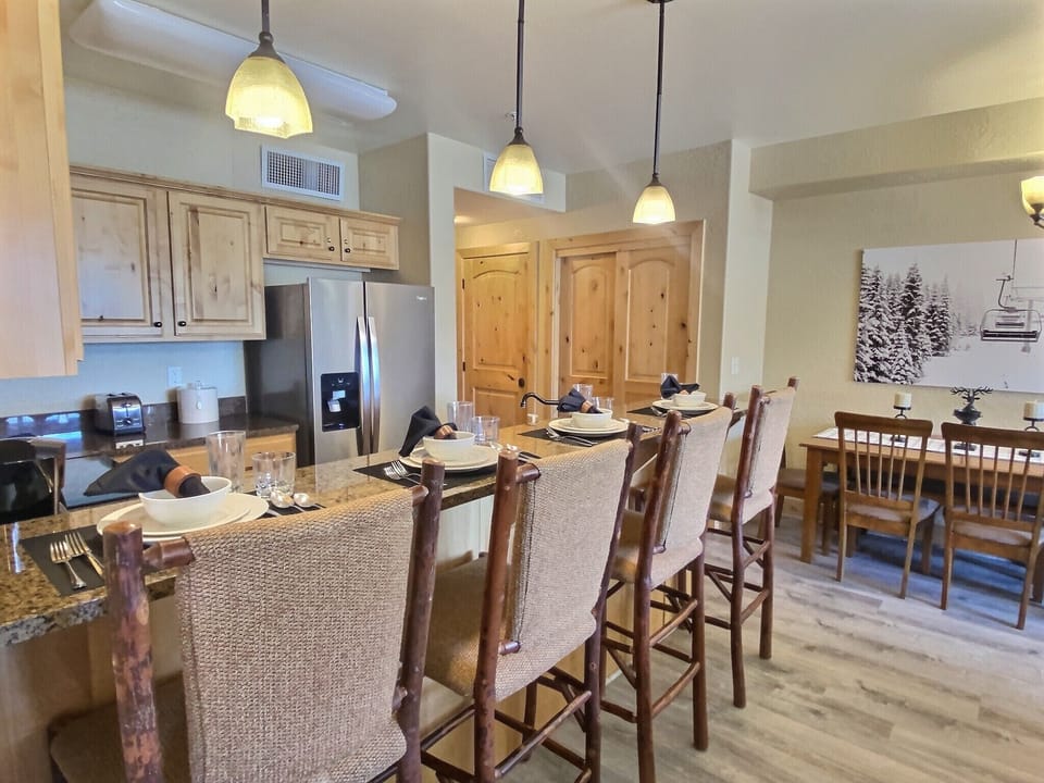 Whip up gourmet meals in this fully equipped kitchen featuring sleek granite countertops, modern stainless steel appliances, and elegant pendant lighting. The open layout makes hosting a breeze!