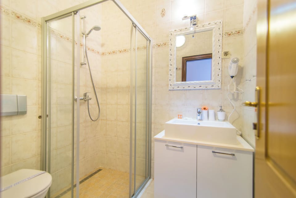 Shower, hair dryer, slippers, towels