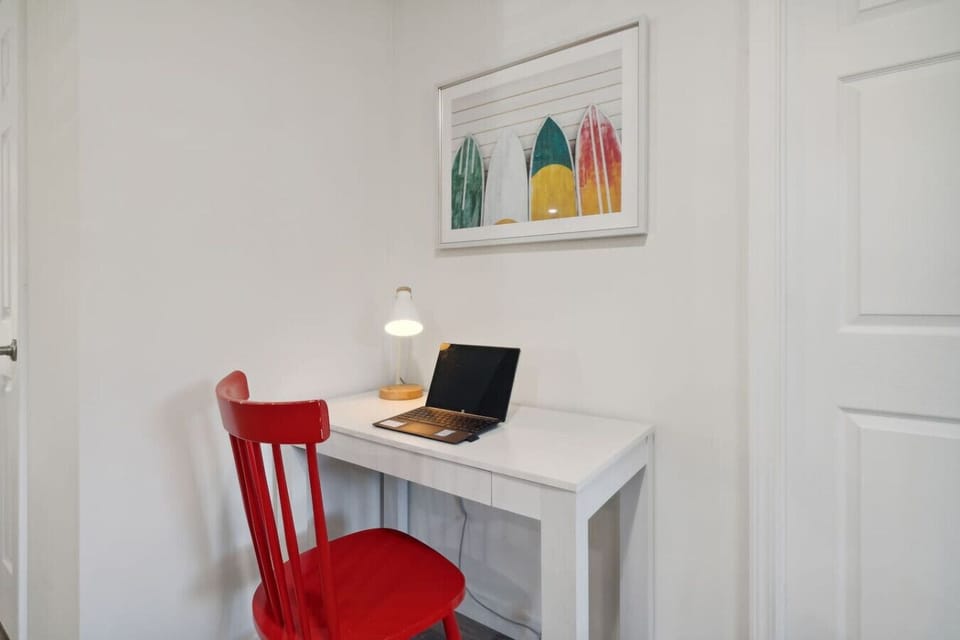 A dedicated workspace with a desk, light, and plenty of room for guests who need to work while enjoying their stay.