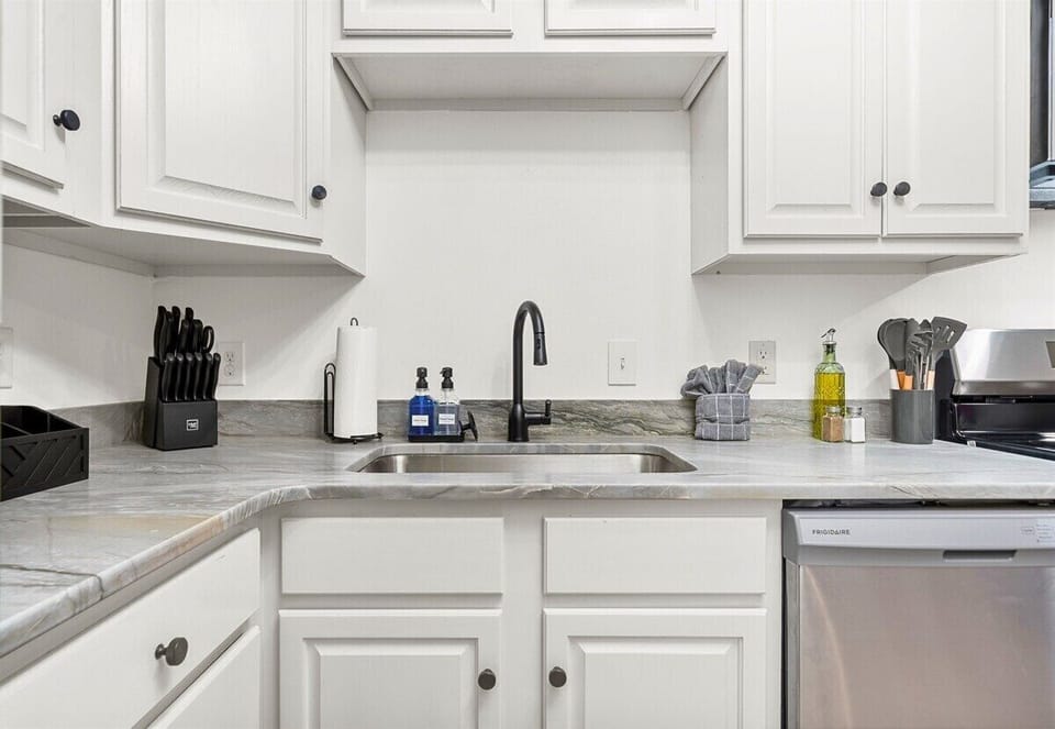 A close-up look at the modern and functional kitchen sink area, complete with all the essentials to make your cooking experience stress-free.