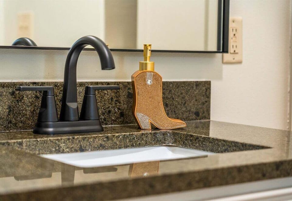 A close-up of the stylish bathroom sink area, where thoughtful details like delightful soap and chic decor create a spa-like experience.