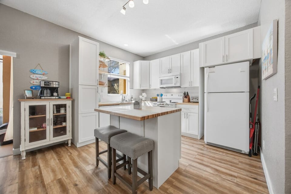 Fully equipped kitchen featuring a breakfast island and stylish seating.
