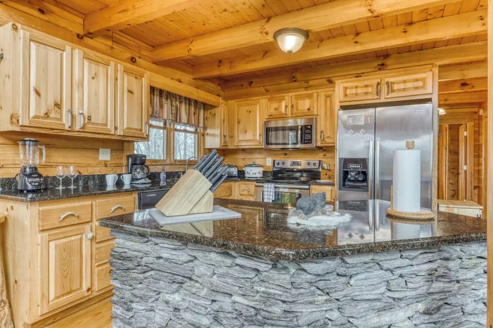 Stocked kitchen with stainless steel appliances ready for multiple families to cook a meal.