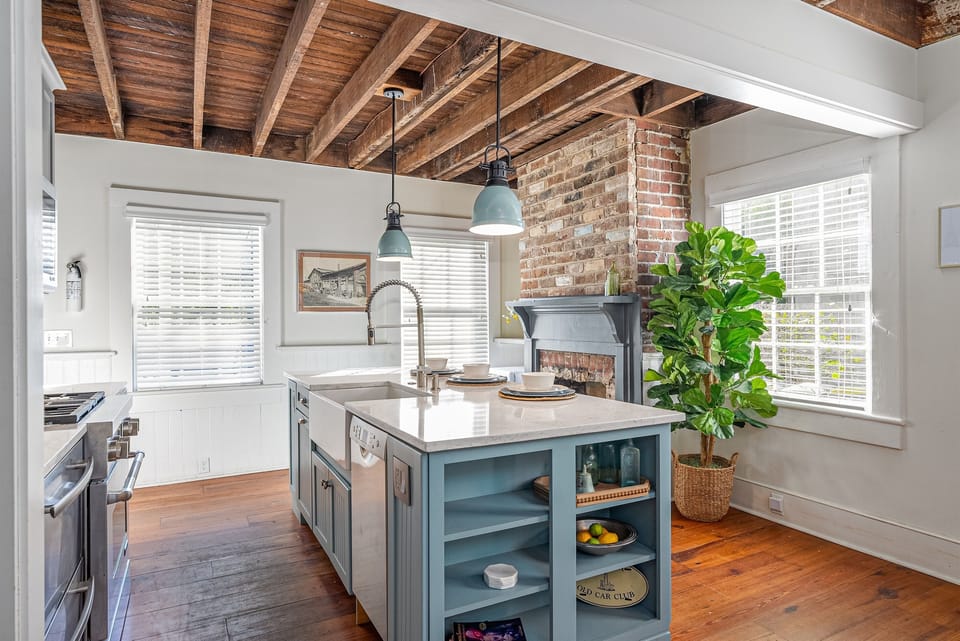 The kitchen island features a convenient breakfast bar with seating for three, perfect for casual meals or morning coffee.