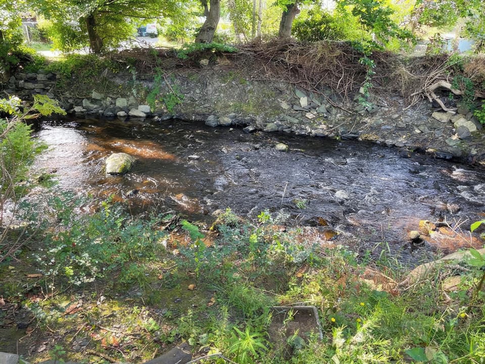 Relax in our large riverside garden and listen to the water of the River Aled passing by as you enjoy your morning coffee. Our riverside garden is fenced to keep small dogs in | Y Ddol, Colwyn Bay