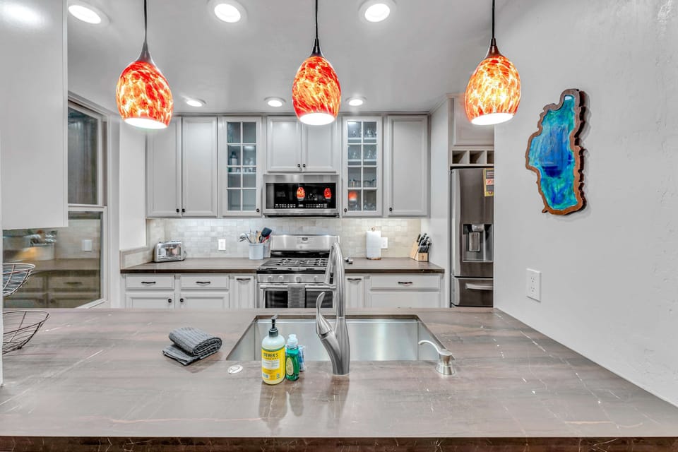 Kitchen: Well-equipped kitchen, Keurig, Crockpot, waffle maker, open layout to living room