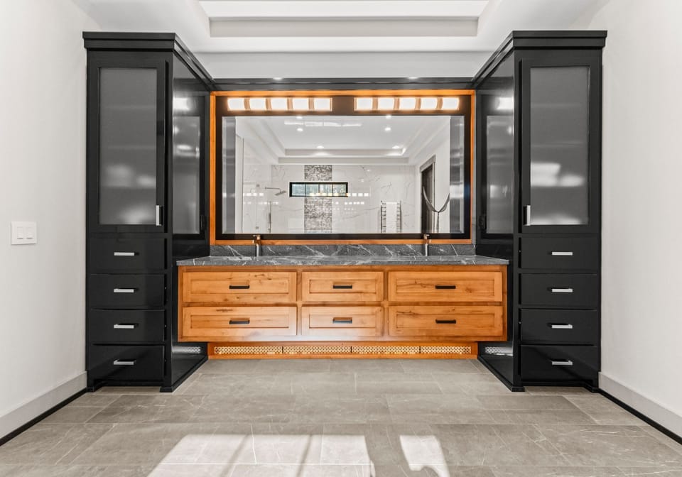Main Level Primary Bathroom with soaking tub,  glass shower, dual vanities & plenty of cabinet space. 