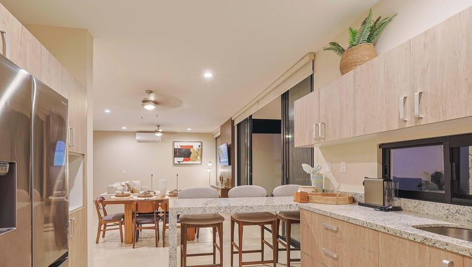 Kitchen and dining area with stylish accents and large windows.