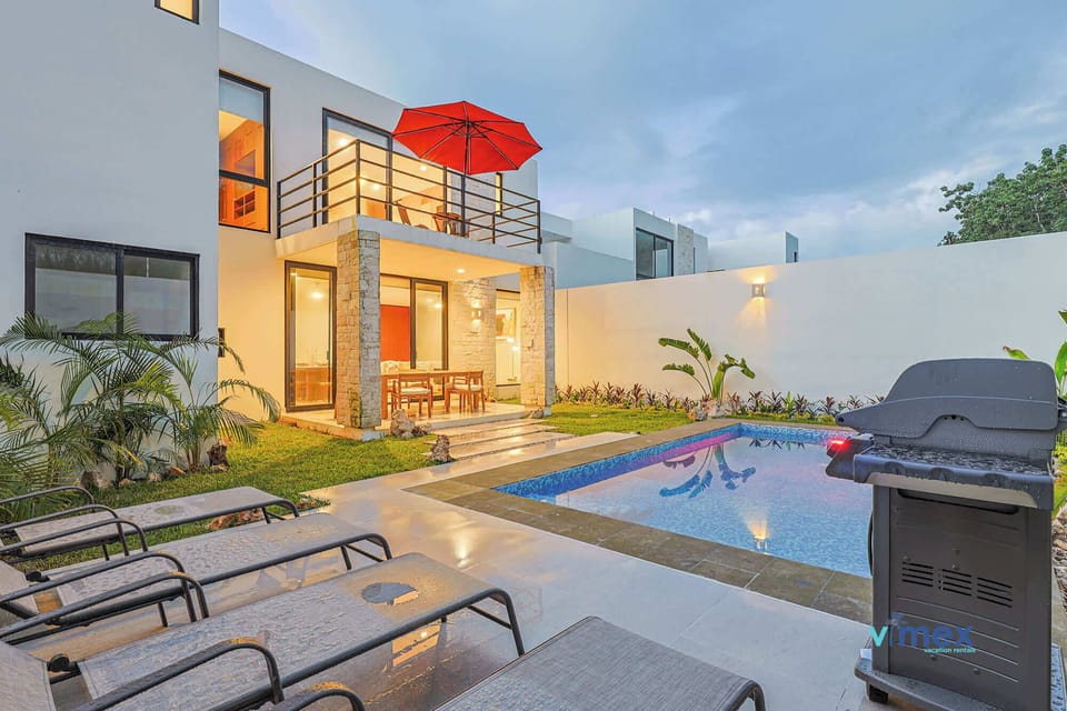 Poolside area with seating and BBQ.