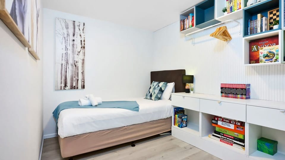 A charming guest room with clever storage and bright energy.