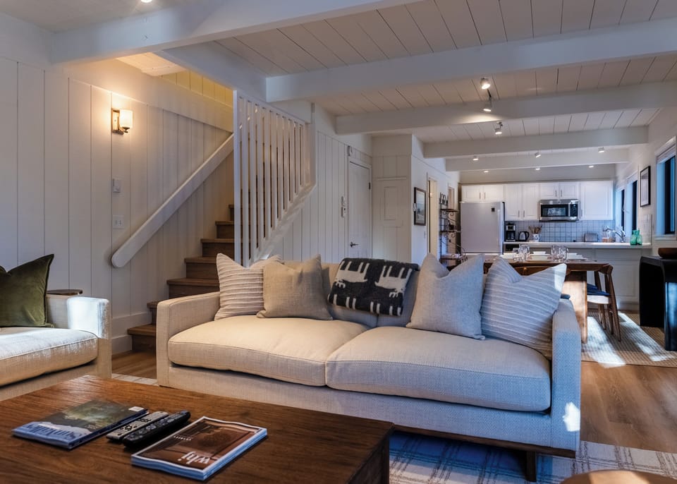 View from living area to dining, kitchen & stairs up to bedrooms