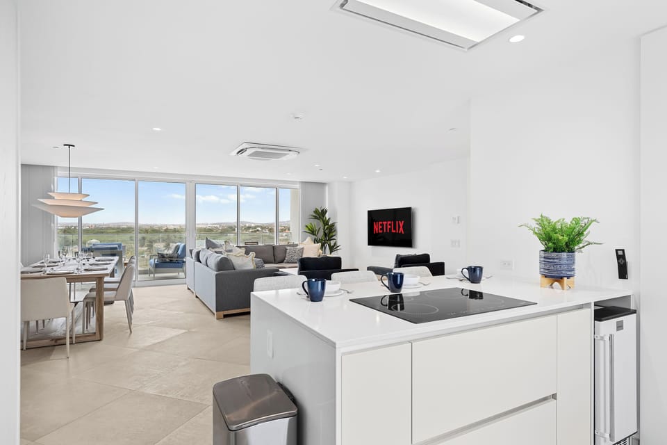 Gather around your sleek open-concept space where natural light floods the kitchen, dining, and living areas. Cook, connect, and unwind in this bright, modern retreat.