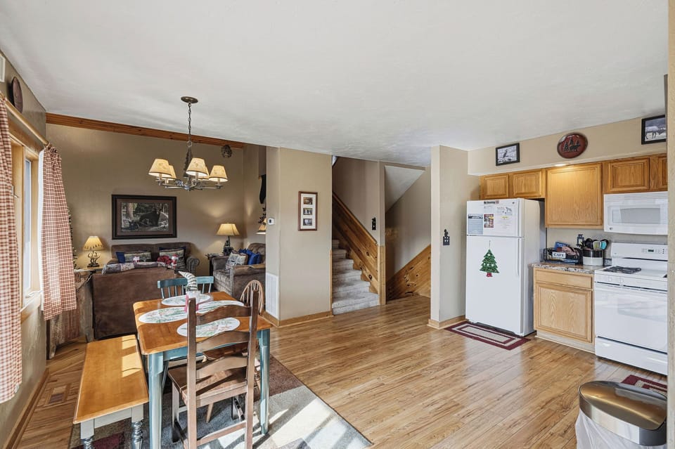 Settle into your cozy open-concept space where warm wood tones and mountain charm create the perfect retreat for memorable meals.