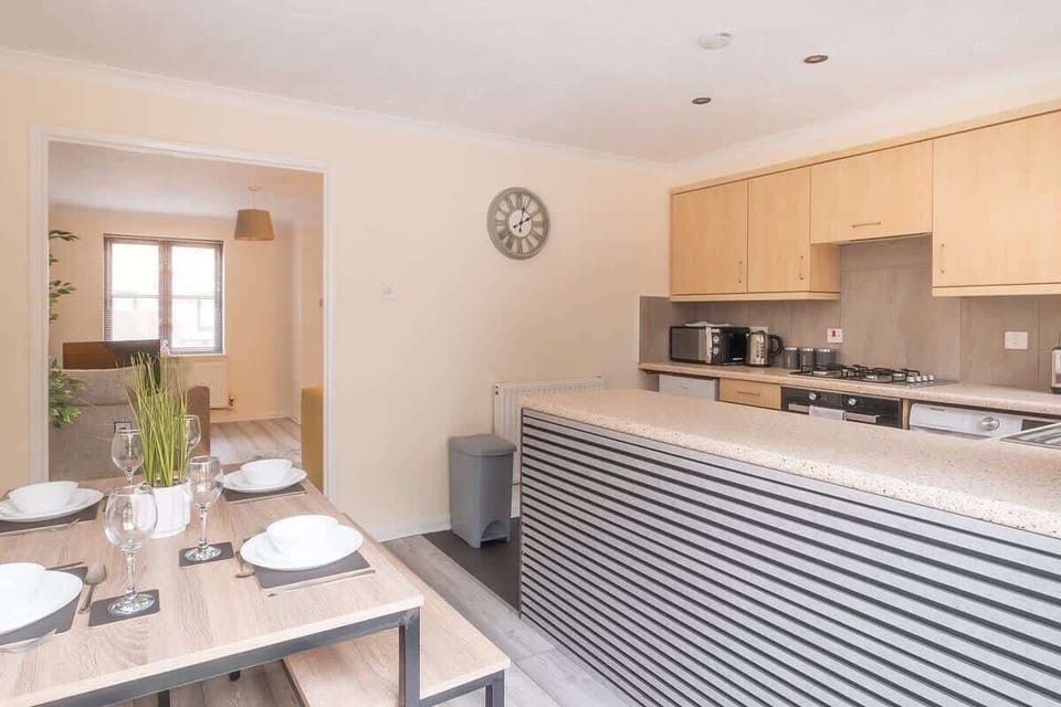 The sleek kitchen offers all the amenities you need, featuring a dining table and seating for a relaxed dining experience