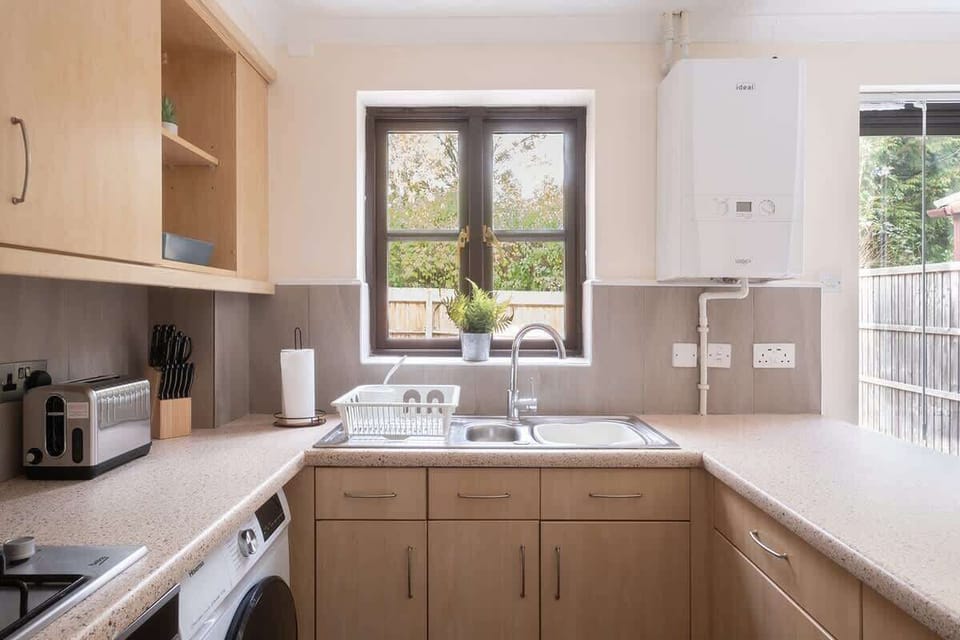 The sleek kitchen offers all the amenities you need, featuring a dining table and seating for a relaxed dining experience