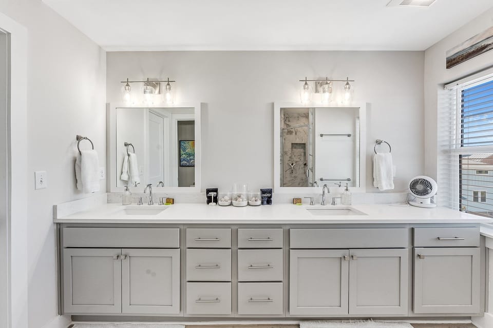 Master Bathroom has double vanity sinks and large shower with tile floor to ceiling