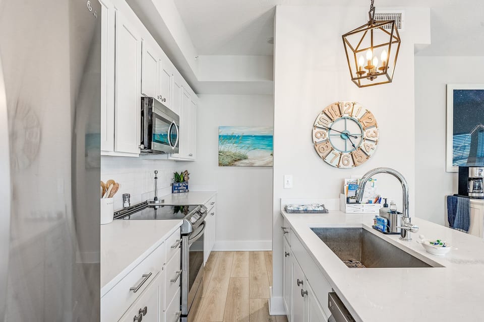 Stocked kitchen with granite counter tops and stainless steel appliances