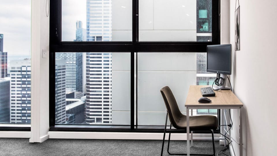 Maximize your focus at this sun-drenched, window-side desk featuring breathtaking urban views.