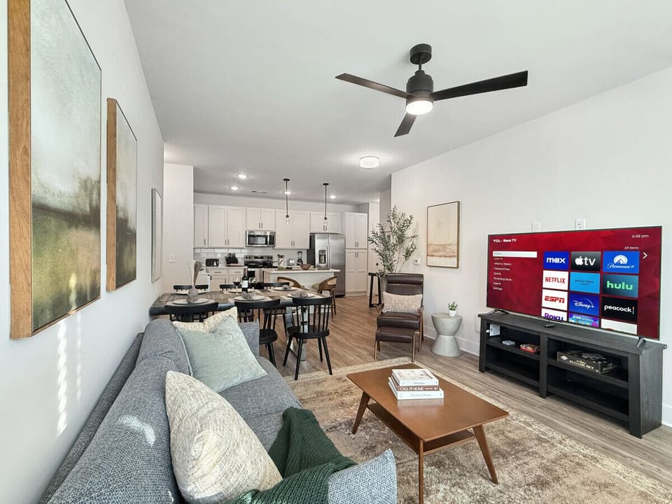 Living room with 55` Roku TV ready for you to access your favorite streaming channels from home!