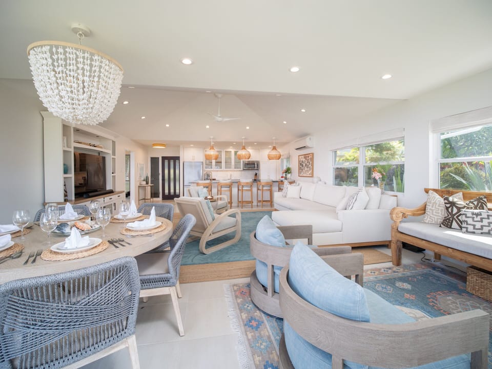 Enjoy a spacious living and dining area with ample seating and ocean views, designed for comfort and relaxation in style.