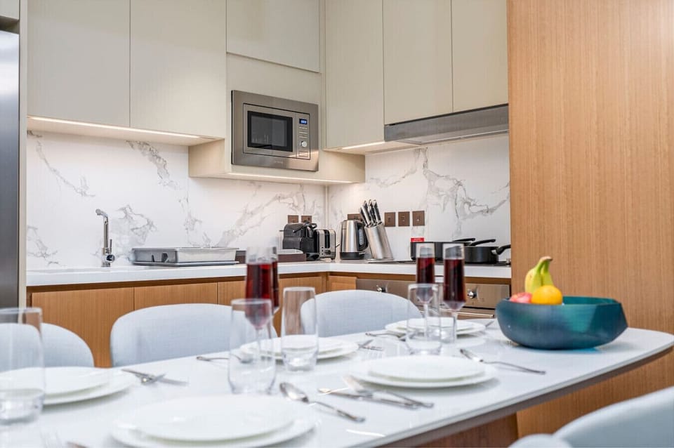 Chic Kitchen: Modern elegance awaits with sleek finishes and a perfect dining setup!