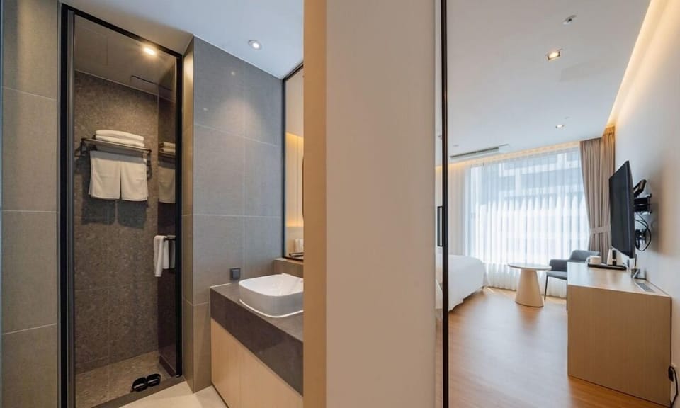 Deluxe Twin Room | Bathroom | Hair dryer, slippers, bidet, towels
