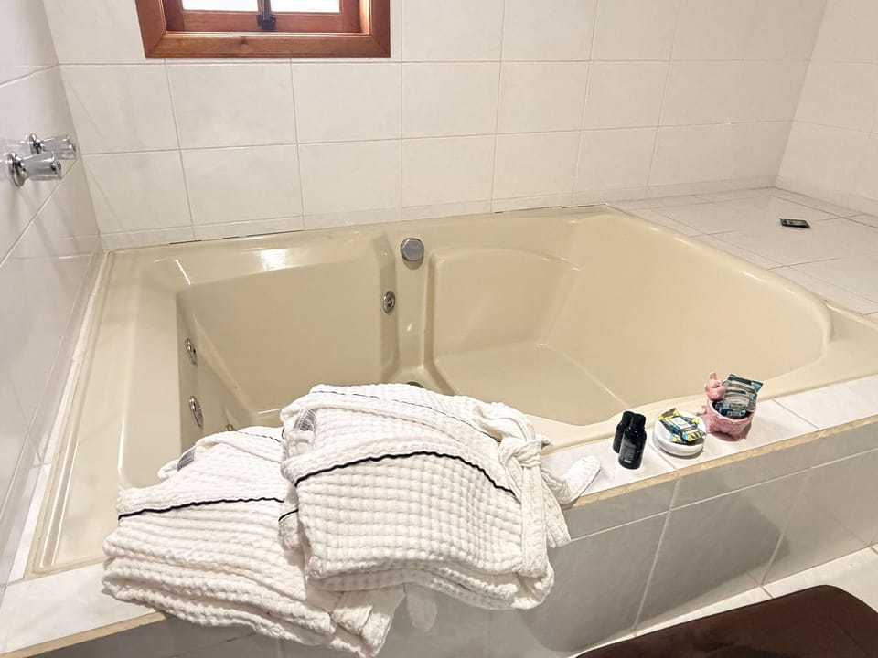 Suite | Bathroom | Separate tub and shower, jetted tub, slippers, towels